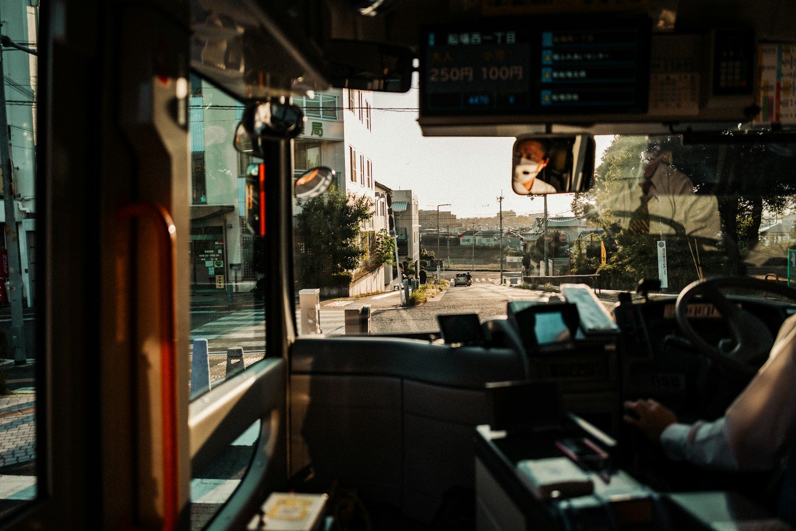 View from bus driver's seat on a sunny day.